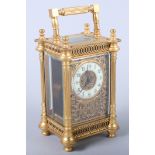 An early 20th century gilt cased carriage clock with painted dial and Arabic numerals, floral