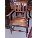 A provincial oak vertical rail back elbow chair with panel seat