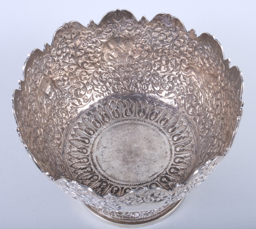 An Indian white metal pedestal fruit bowl, embossed and engraved with wild animals on a scrolled - Image 2 of 8