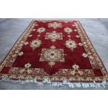 A wool pile "Louis de Poortere" carpet with three medallions on a red ground, 98" x 138" approx