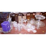 A collection of cut, etched and moulded glassware, including glasses, cake stands, a claret jug,