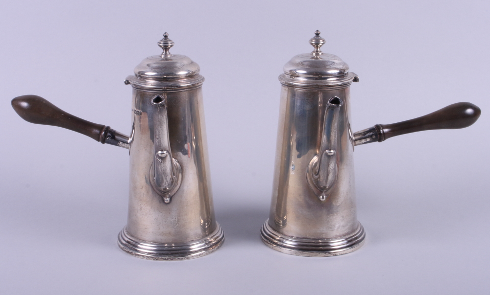 A pair of George V Asprey & Co silver coffee pots, each with turned horn handles, on stepped