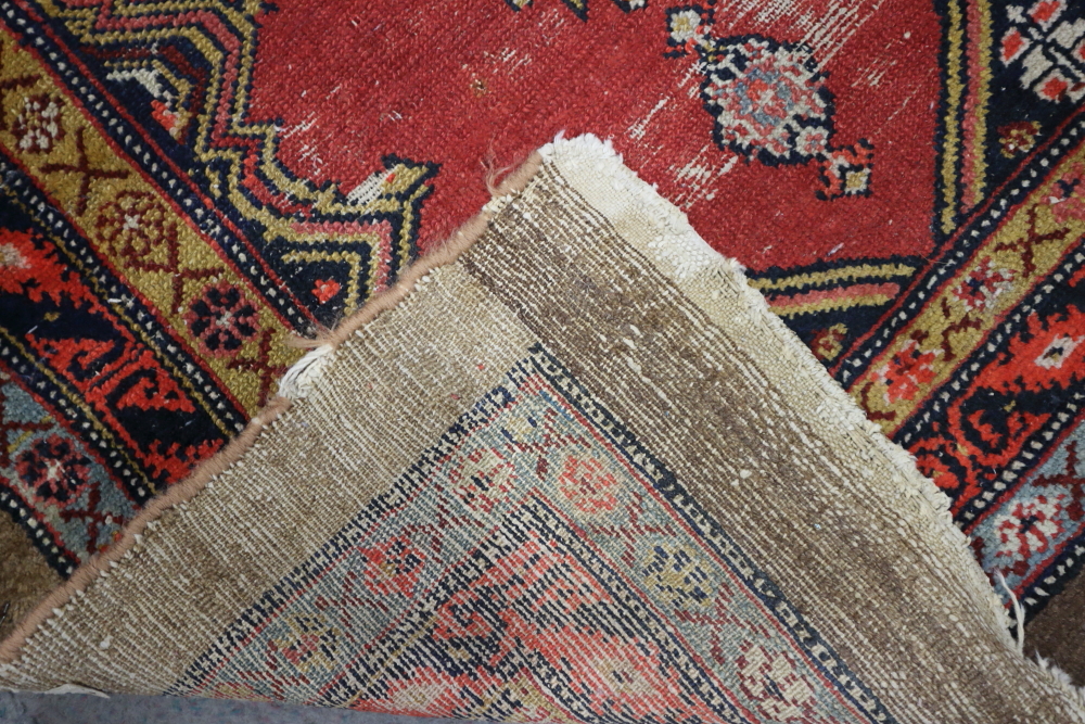 A Persian tribal runner with two hexagonal blue guls on a red ground, 94" x 33" approx (slight - Image 2 of 2