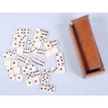 A quantity of 19th century bone miniature dominoes, in a mahogany box