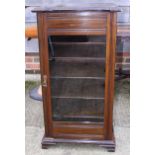 An Edwardian mahogany music cabinet enclosed glazed door, on splay bracket supports, 19" wide