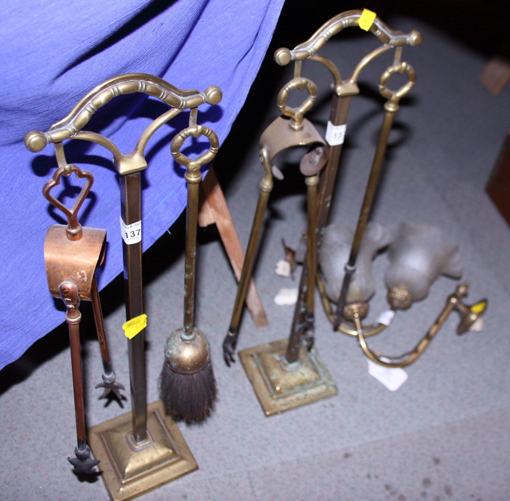 Two brass companion stands, four fire irons and a pair of brass wall lights and shades