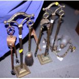 Two brass companion stands, four fire irons and a pair of brass wall lights and shades
