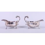 A pair of Victorian silver sauce boats with scroll handles, on hoof feet with shell shoulders, 11.