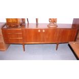 An A H McIntosh teak side board, fitted three drawers, centre cupboard and drop front cocktail