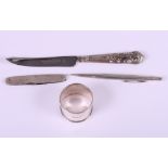 A silver napkin ring, a silver handled cheese knife, a silver pocket knife and silver "Life Long"