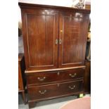 An early 19th century mahogany linen press enclosed two doors over two long drawers, on bracket
