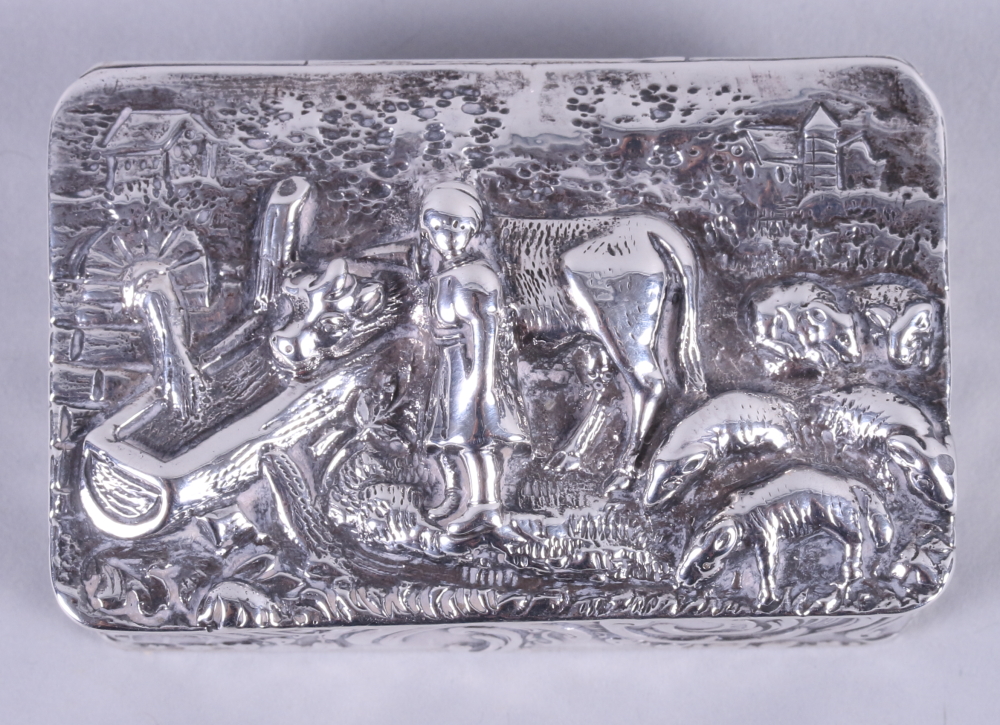 A late 19th century Dutch scroll decorated silver box, embossed a girl with oxen and sheep, 1.5oz