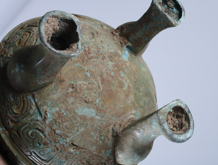 A Chinese bronze Archaic design two-handled foot vessel with relief cast dragon decoration, on three - Image 3 of 3