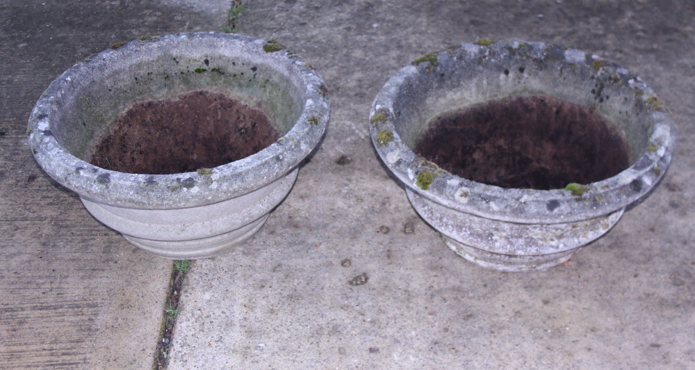 A pair of cast stone circular planters, 24" wide