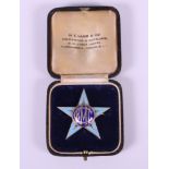 A silver gilt and enamel Royal Masonic College for Girls prefect's badge, presented to Barbara