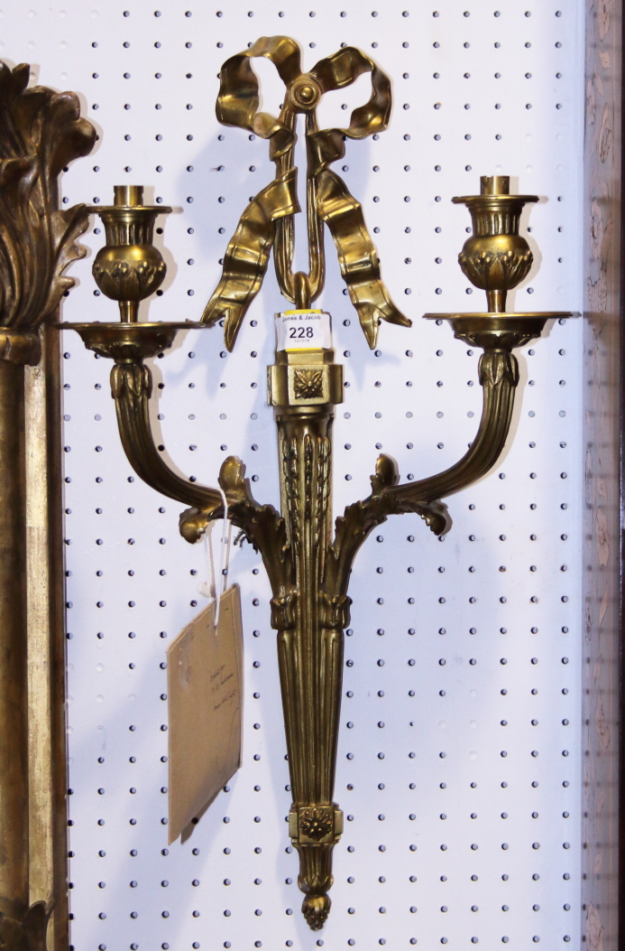 An early 20th century brass two-light wall bracket of Adam design, 21 1/2" high