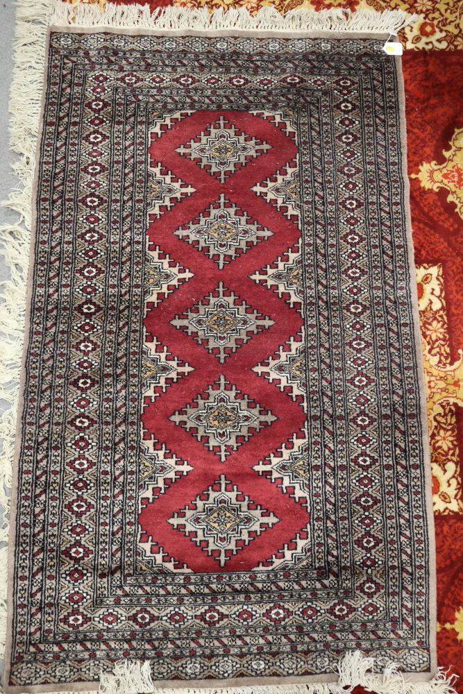 A Pakistan Bokhara rug with five star guls on a red ground, 64" x 38" approx