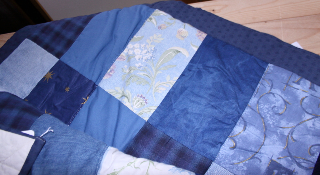 A patchwork quilt with rectangular panels of denim, corduroy and other predominantly blue fabrics, - Image 2 of 3