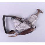 A white metal armorial khanjar from the Sultanate of Oman, on leather strap with horn handle