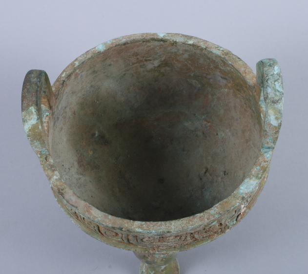 A Chinese bronze Archaic design two-handled foot vessel with relief cast dragon decoration, on three - Image 2 of 3