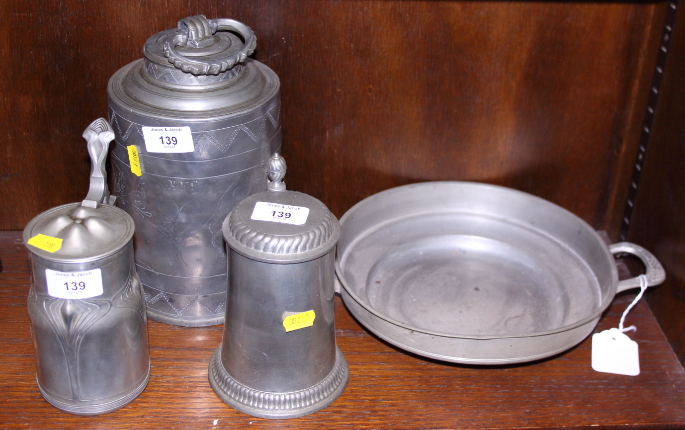 An Art Nouveau pewter lidded tankard, another, a 19th century engraved food container and cover, and