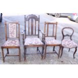 A ladderback chair with rush seat, an oak elbow chair and two matching standard chairs