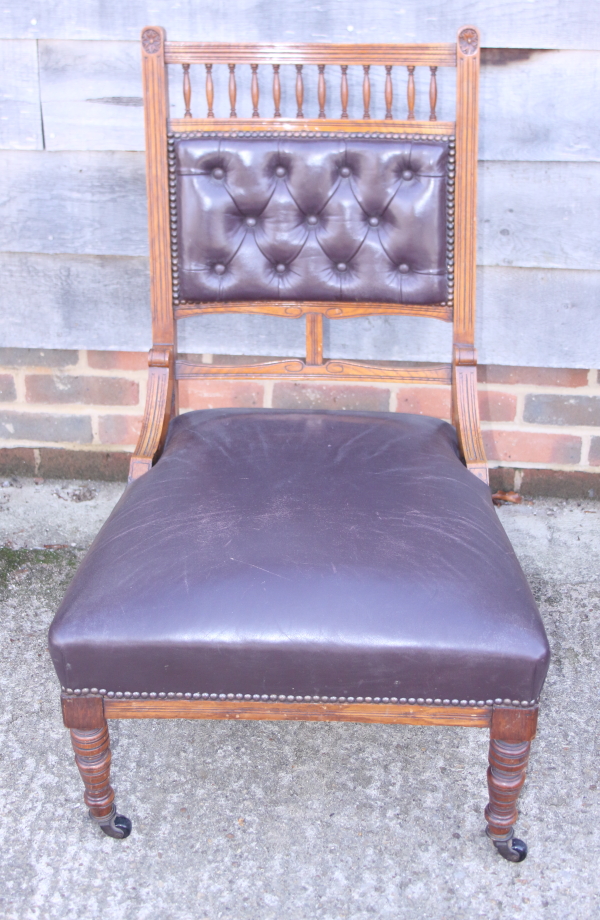 An Edwardian walnut open armchair, button upholstered in a brown leather, and a companion nursing - Image 2 of 3