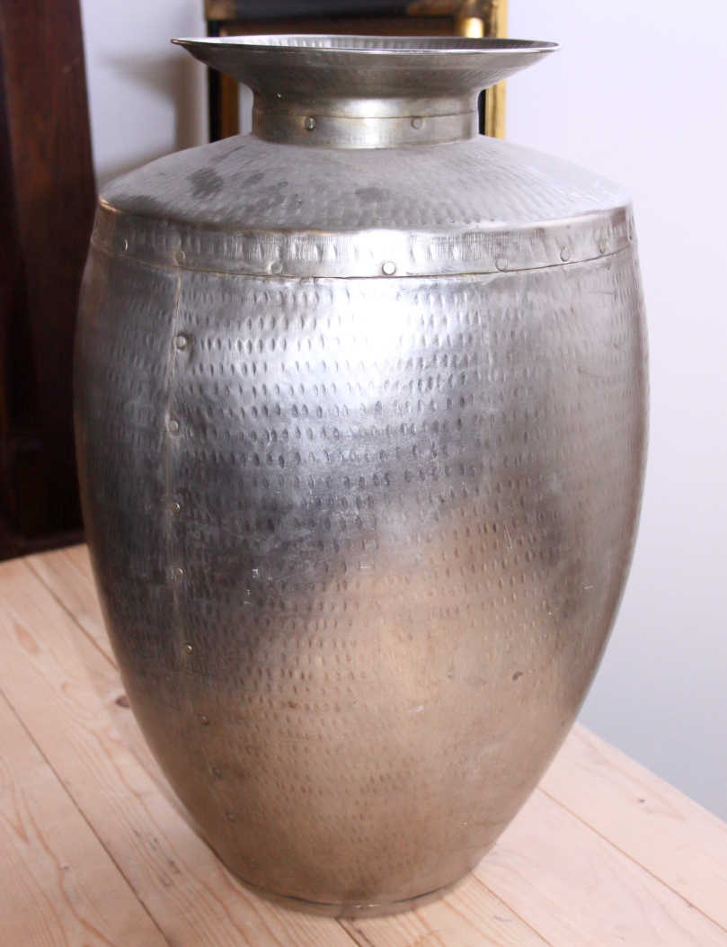 A hammered steel jar with flared rim, 23" high