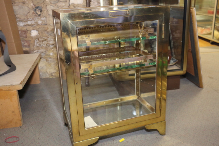 A surgeon's John Weiss & Sons bronze and plate glass instrument cabinet, 15 1/2" wide x 21" high x