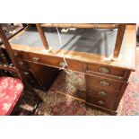 An early 20th century mahogany double pedestal desk, fitted nine drawers with blue leather lined