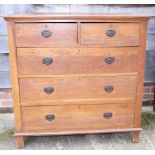 An Arts & Crafts oak chest of two short and three long drawers with brass ring handles, 41" wide