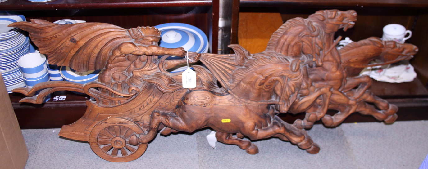 A carved softwood wall hanging, Apollo in his chariot, 46" long