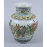 A 19th century Chinese porcelain famille vert baluster vase, decorated figures within a rocky