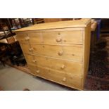 A stripped pine chest of two short and three long drawers with knob handles, on turned supports, 42"
