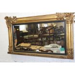 A 19th century oval giltwood framed overmantel mirror with acanthus decoration, plate 16 1/2" x 32