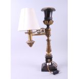 A late 19th century cast bronze and gilt Federal design table lamp with applied acanthus leaf