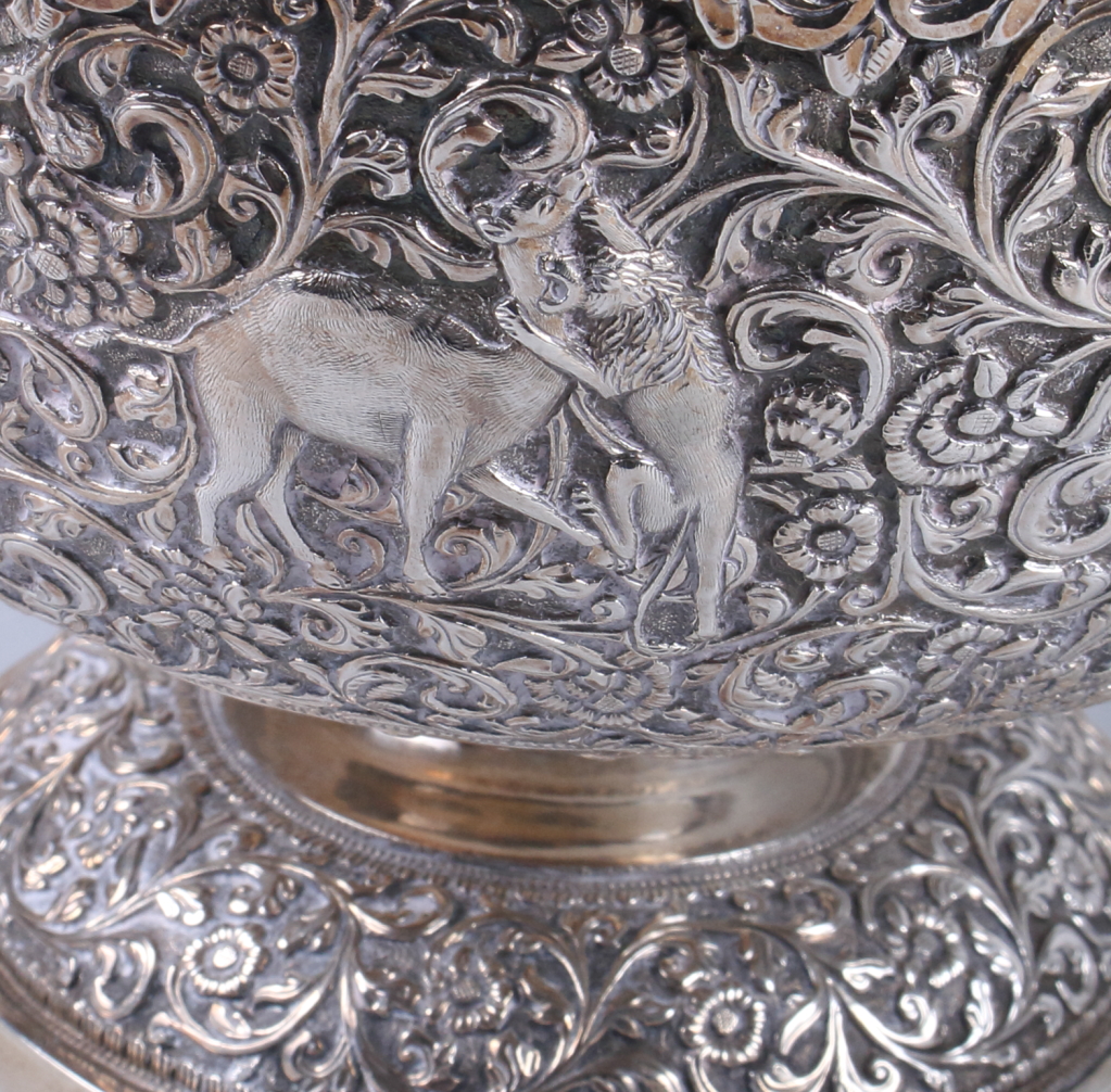An Indian white metal pedestal fruit bowl, embossed and engraved with wild animals on a scrolled - Image 6 of 8