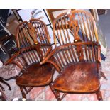 A pair of Windsor splat back elbow chairs with panel seats and crinoline stretchers