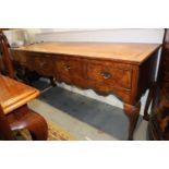 A burr walnut dresser base of early 18th century design, fitted four drawers, on cabriole supports