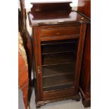 An Edwardian mahogany shape front music cabinet enclosed glazed panel door, 19" wide