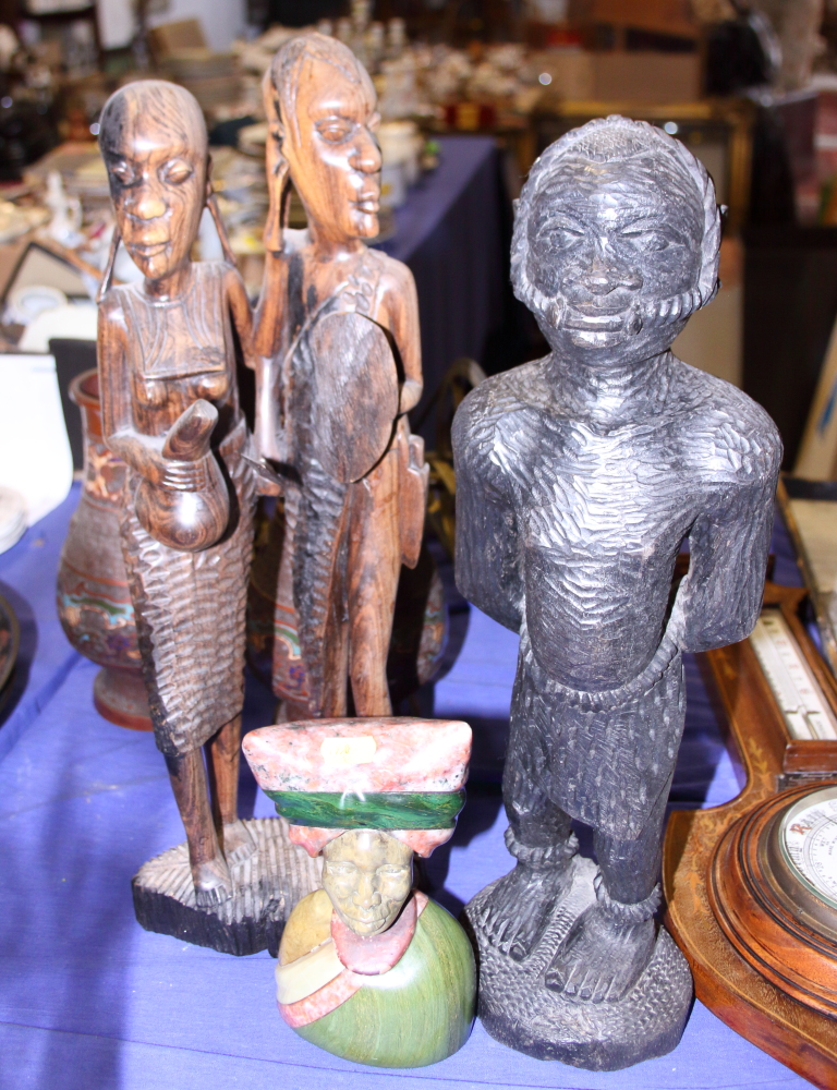 An African carved hardstone portrait bust, 7" high, and two African hardwood figures, 19" high