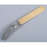 An ivory letter opener/page turner with embossed silver handle, 10" long
