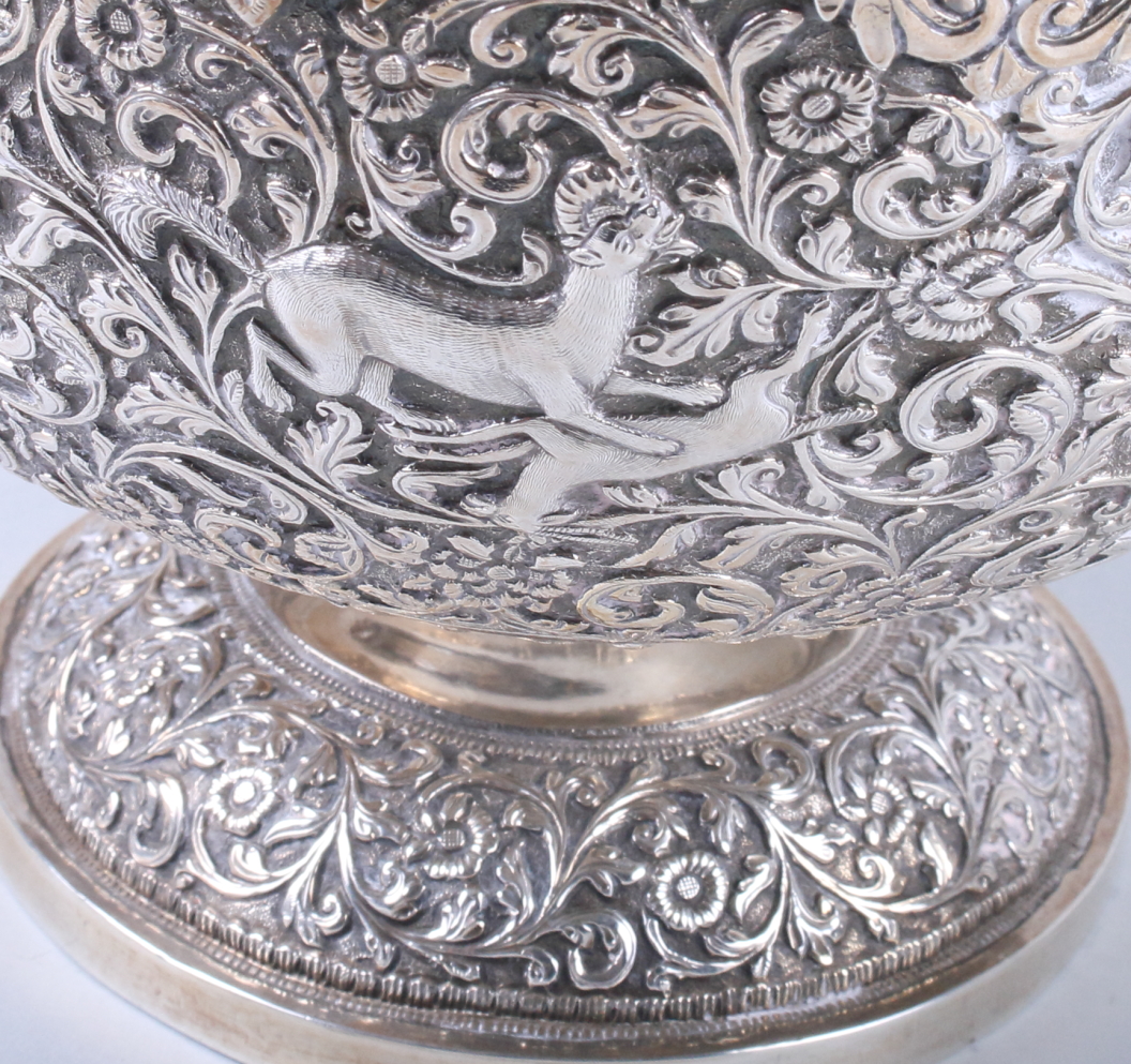 An Indian white metal pedestal fruit bowl, embossed and engraved with wild animals on a scrolled - Image 7 of 8