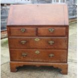 A Georgian oak fall front bureau with fitted interior over two short and two long drawers, 35" wide