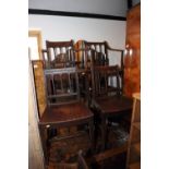 A set of six early 19th century provincial vertical rail back dining chairs with panel seats, on