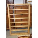 A stripped pine open seven-tier wall shelf, 29" wide