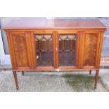 A mahogany side cabinet enclosed Gothic lattice glazed doors, on square taper supports, 50" wide