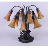 An Art Nouveau Tiffany style twelve-light table lamp, on water lily base, 21" high