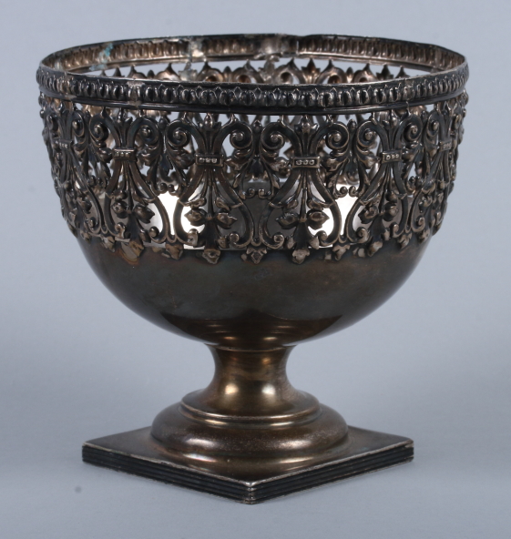 A George V silver pedestal bowl with pierced leaf and scroll decoration, on turned base and reeded