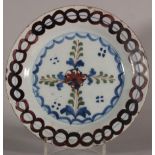 An 18th century Lambeth delft plate with geometric and leaf decoration, 9" dia (restored rim) c1750